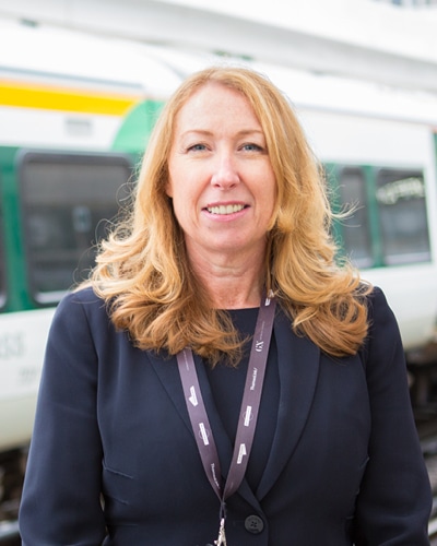 a woman standing in front of a train